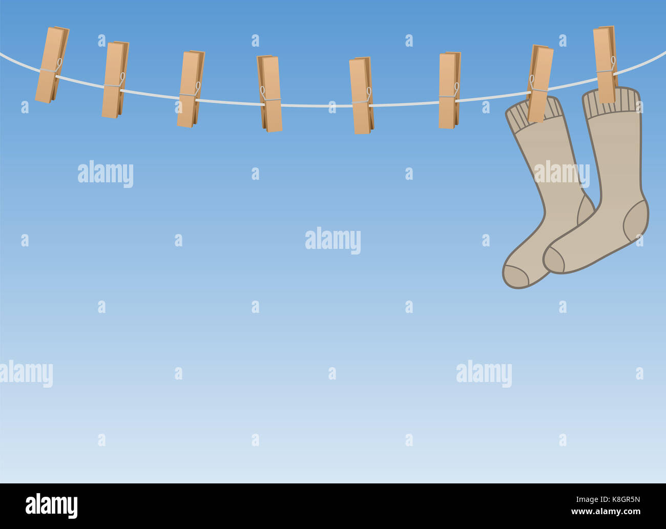 Lonesome socks hanging all alone on a clothes line - symbol for loneliness, solitude, sadness, melancholy of a single person or sorrow Stock Photo