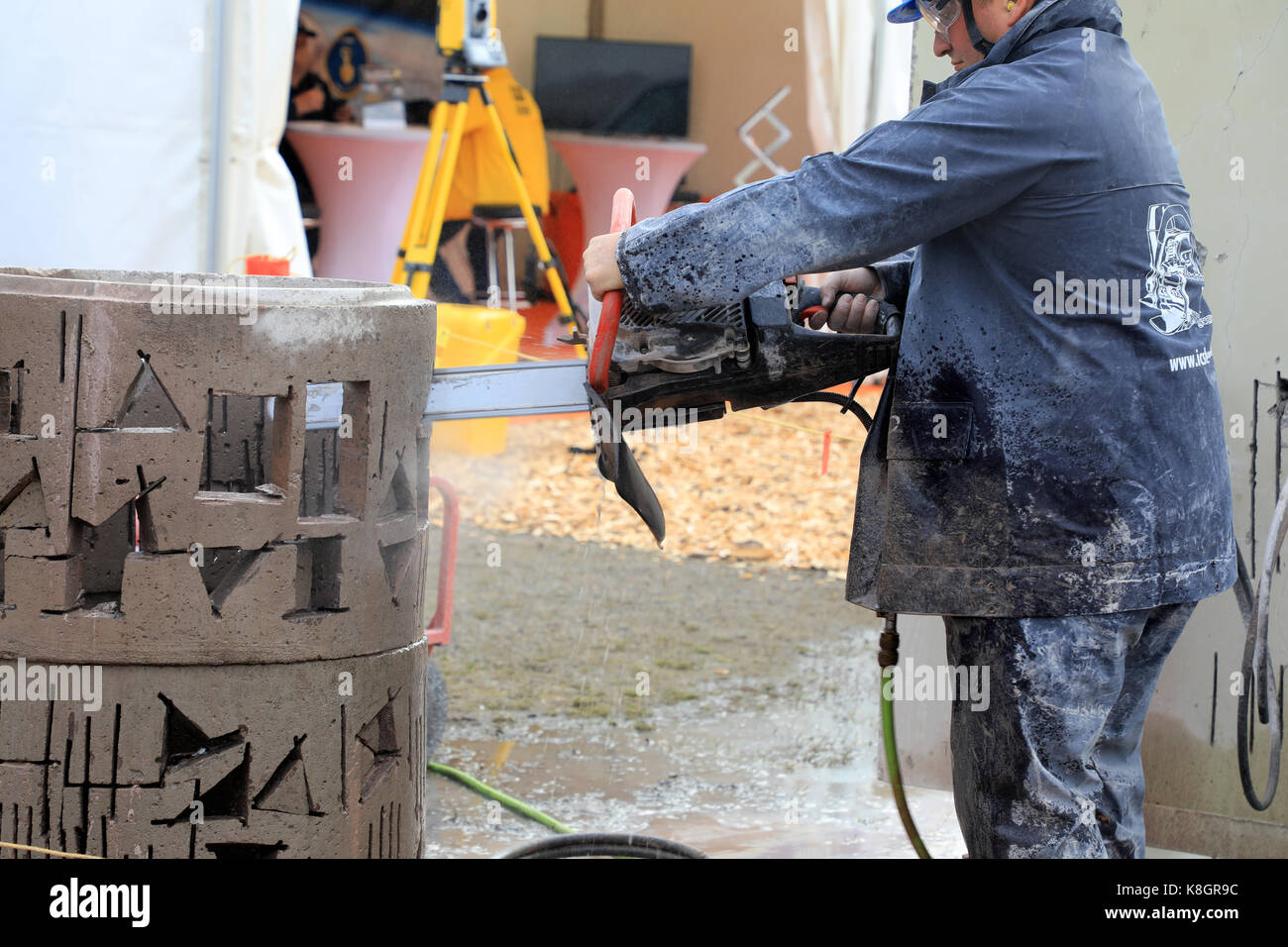 HYVINKAA, FINLAND - SEPTEMBER 8, 2017: Chainsaw operator saws precise openings in concrete with ICS Chain Saw on Maxpo 2017. Stock Photo