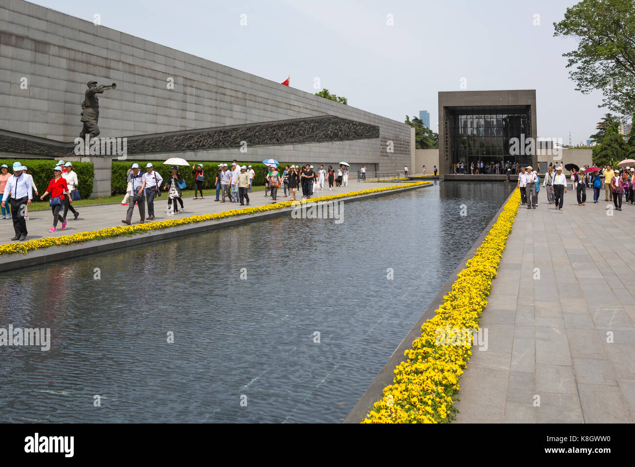 Chinese visitors Nanjing Massacre Memorial pass a pond, China Stock Photo