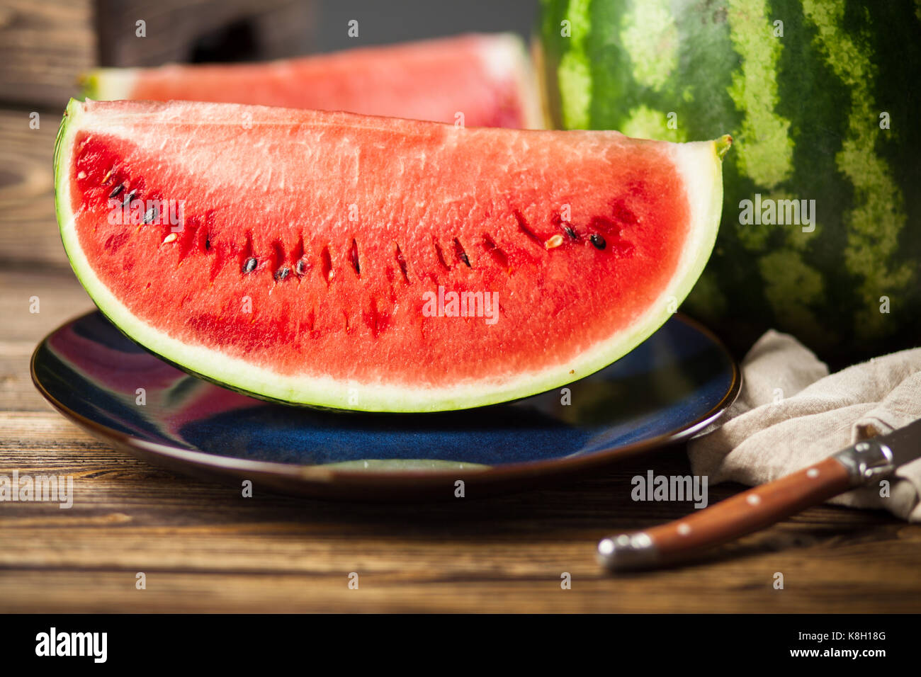 Ripe juicy watermelons on a wooden table Stock Photo