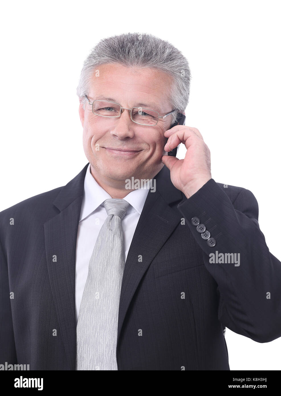 Portrait of smiling senior businessman standing against white Stock ...