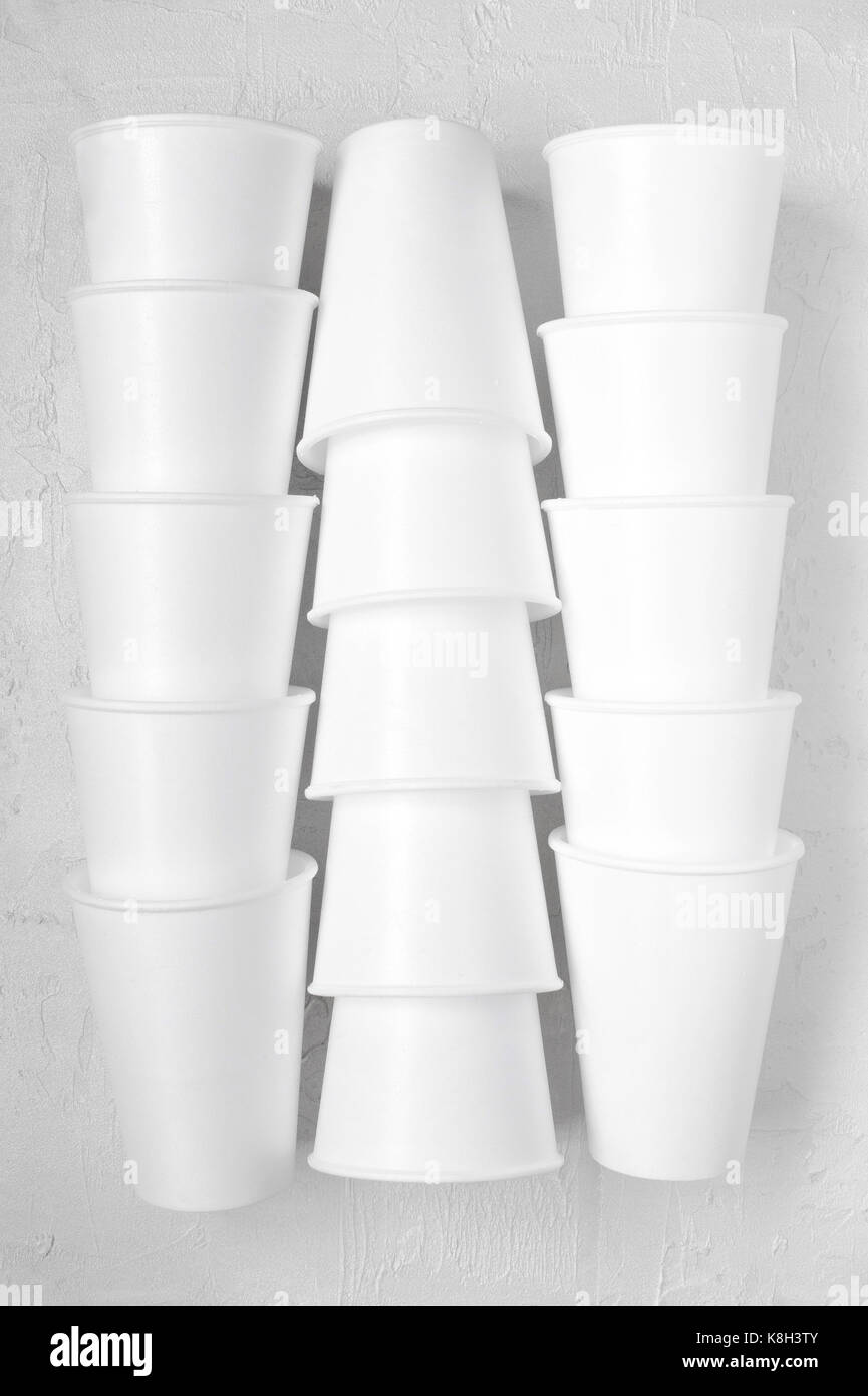 Stacks styrofoam empty cups on the white textured table Stock Photo