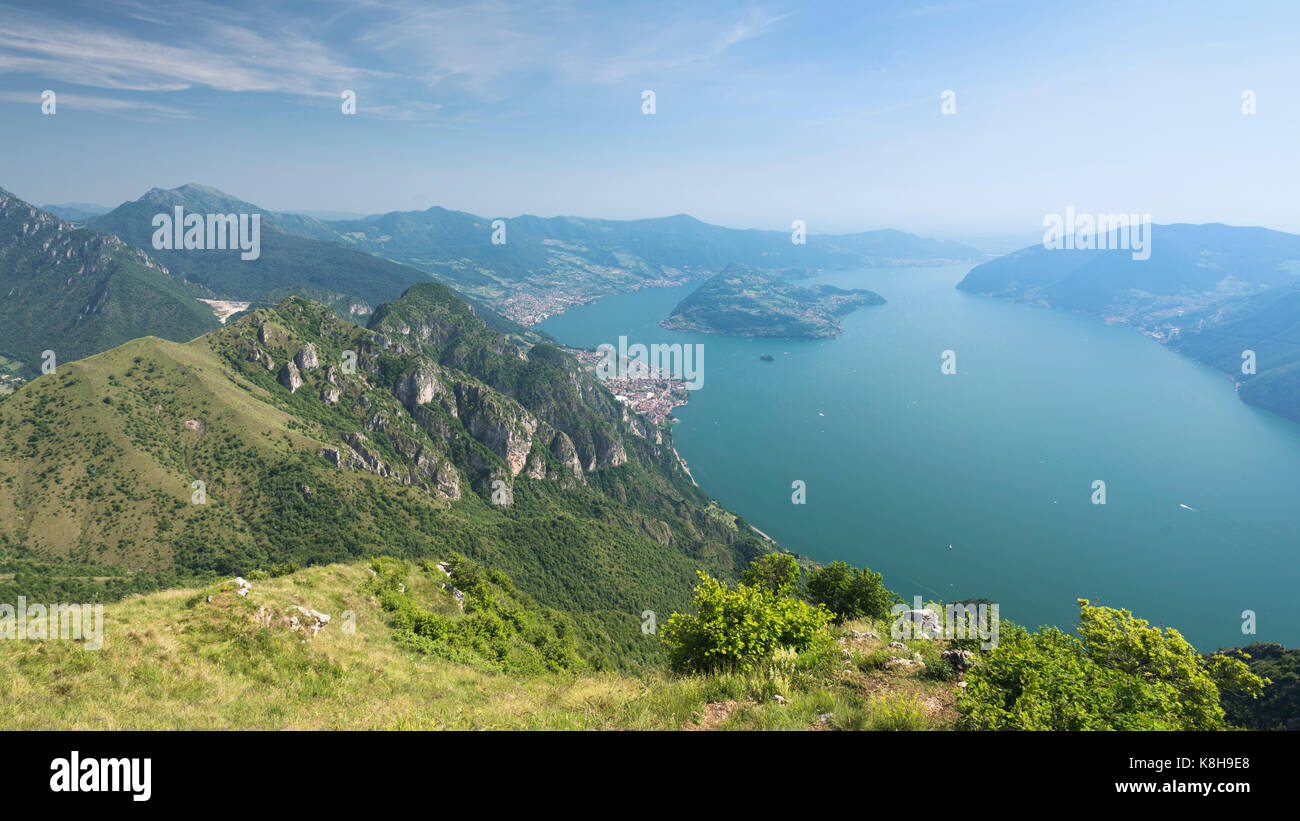 Panorama view on Lake Iseo and surrounding mountains from Mount Trentapassi in afternoon sun, Lombardy, Italy Stock Photo