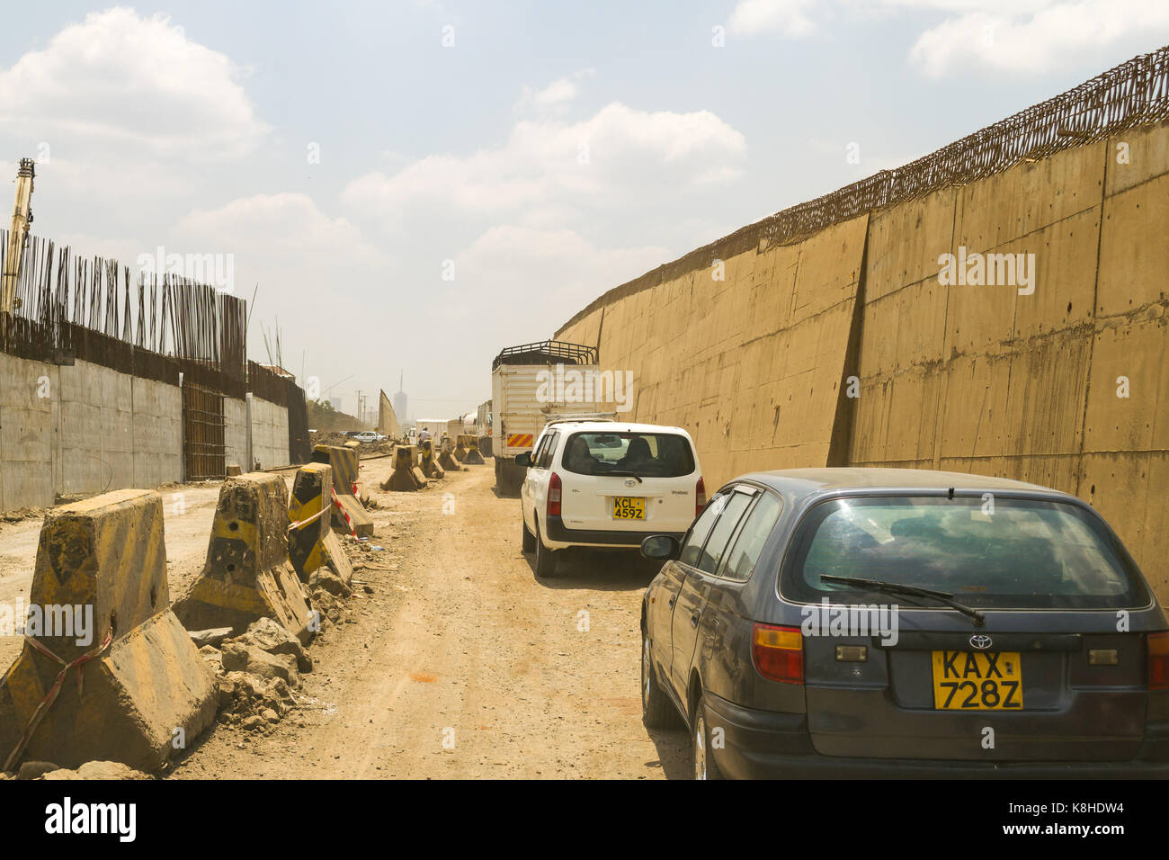 Vehicles drive down Enterprise Road whilst under construction, Nairobi, Kenya Stock Photo