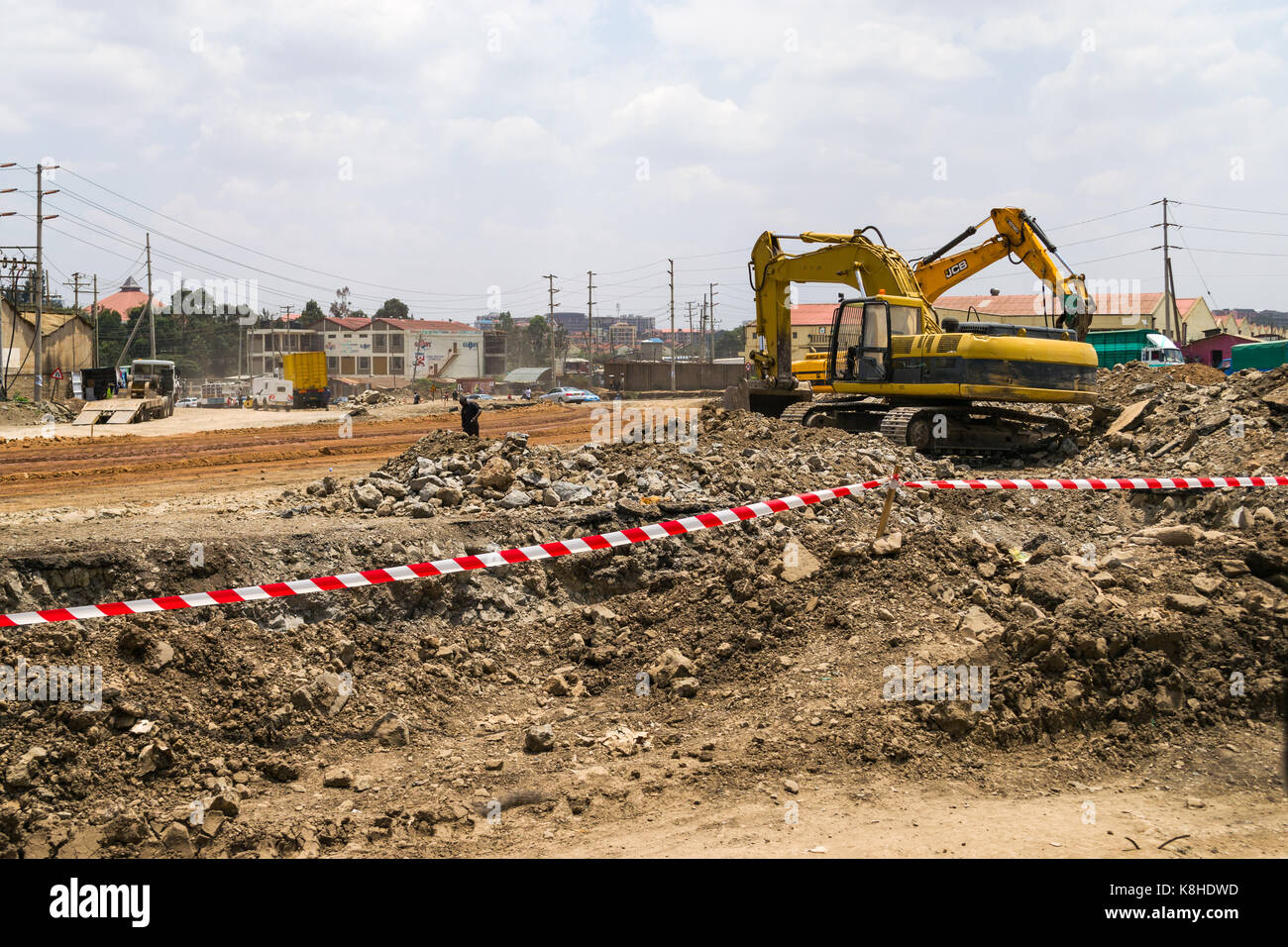 Heavy construction equipment vehicles and rubble line the junction of