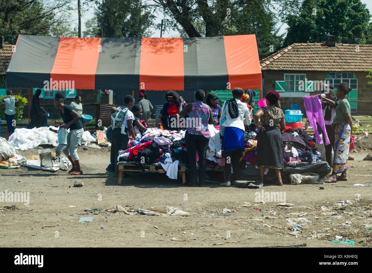 Several women browse through clothes on stall by roadside, Nairobi, Kenya Stock Photo