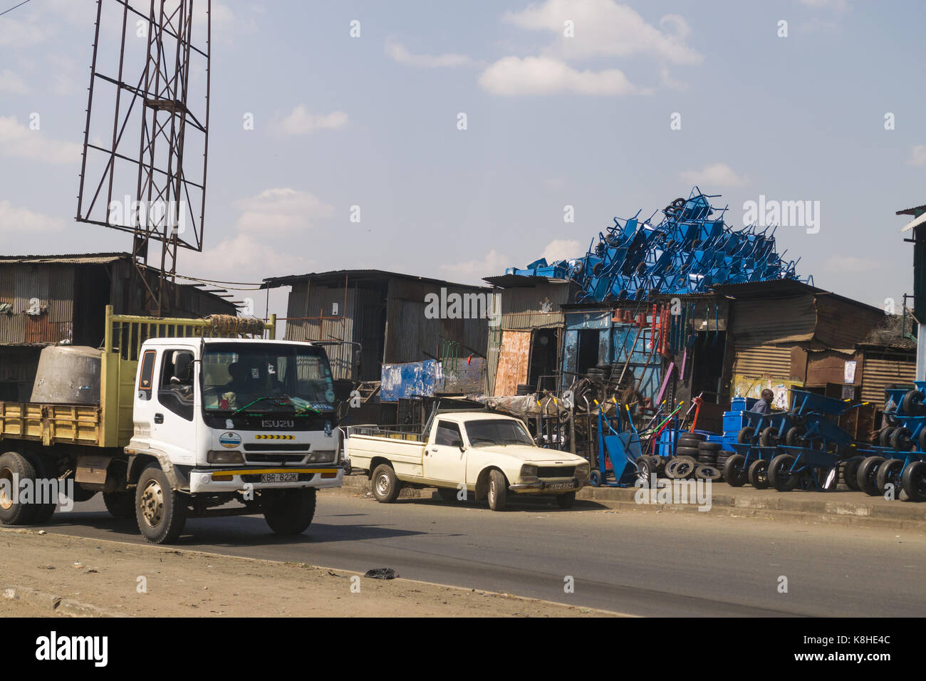 Roadside shop with wheelbarrows and other products for sale as vehicles
