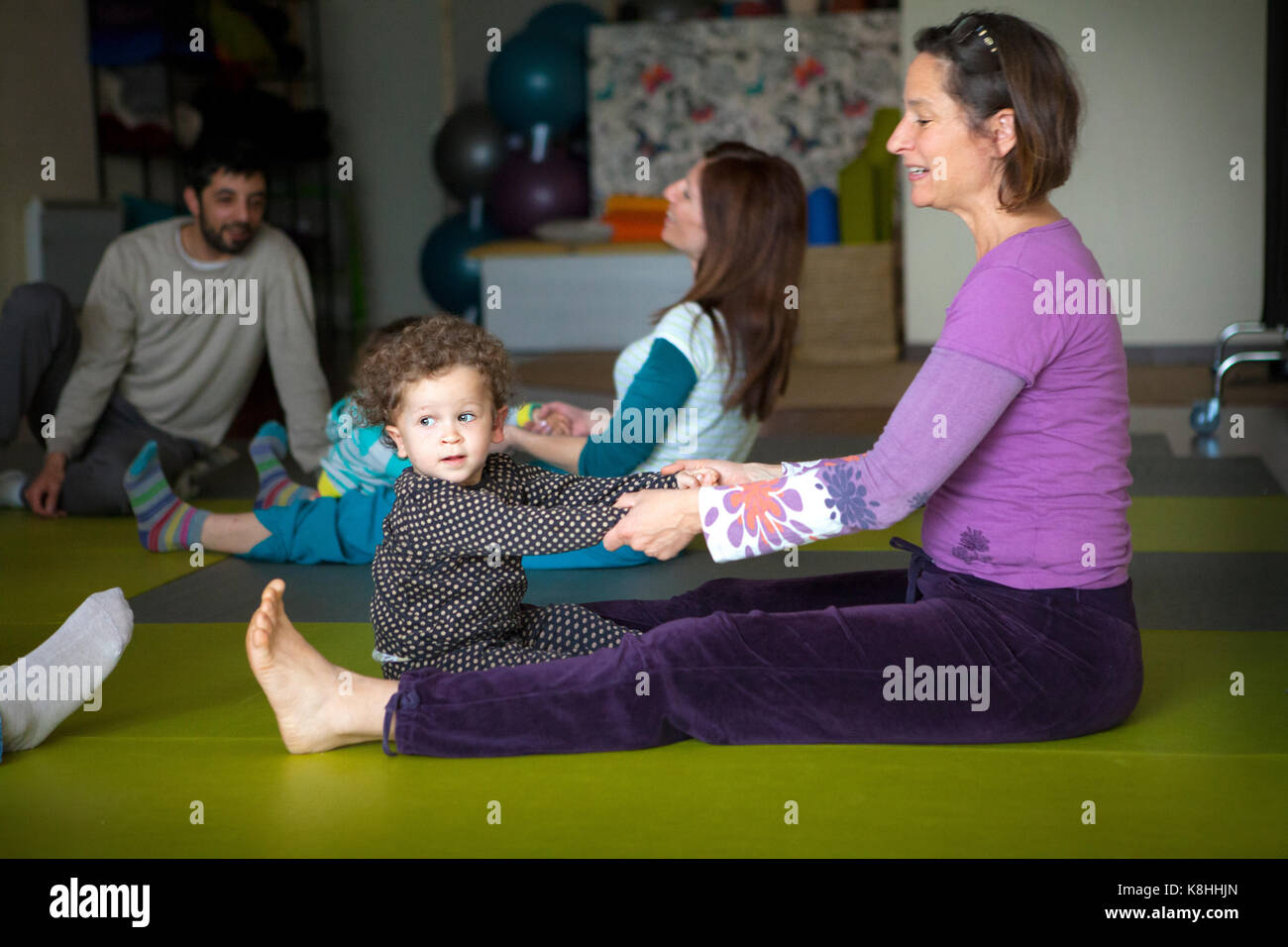 PARENT AND CHILD PRACTICING YOGA Stock Photo