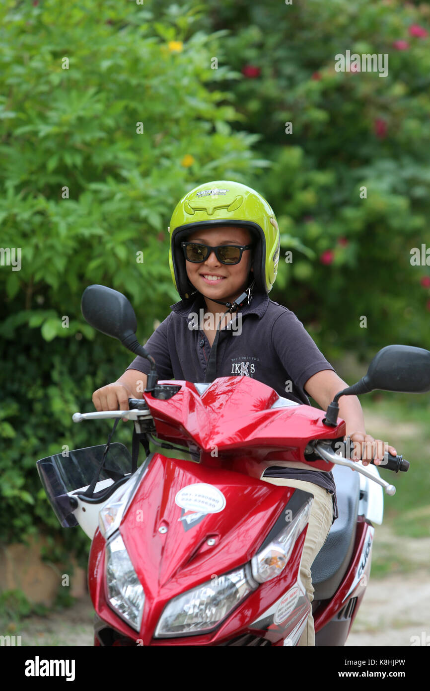 Boy on a scooter. thailand. Stock Photo