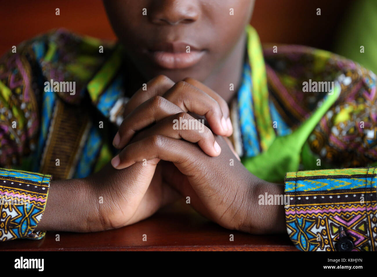 Sunday morning catholic mass. young boy praying. lome. togo. Stock Photo