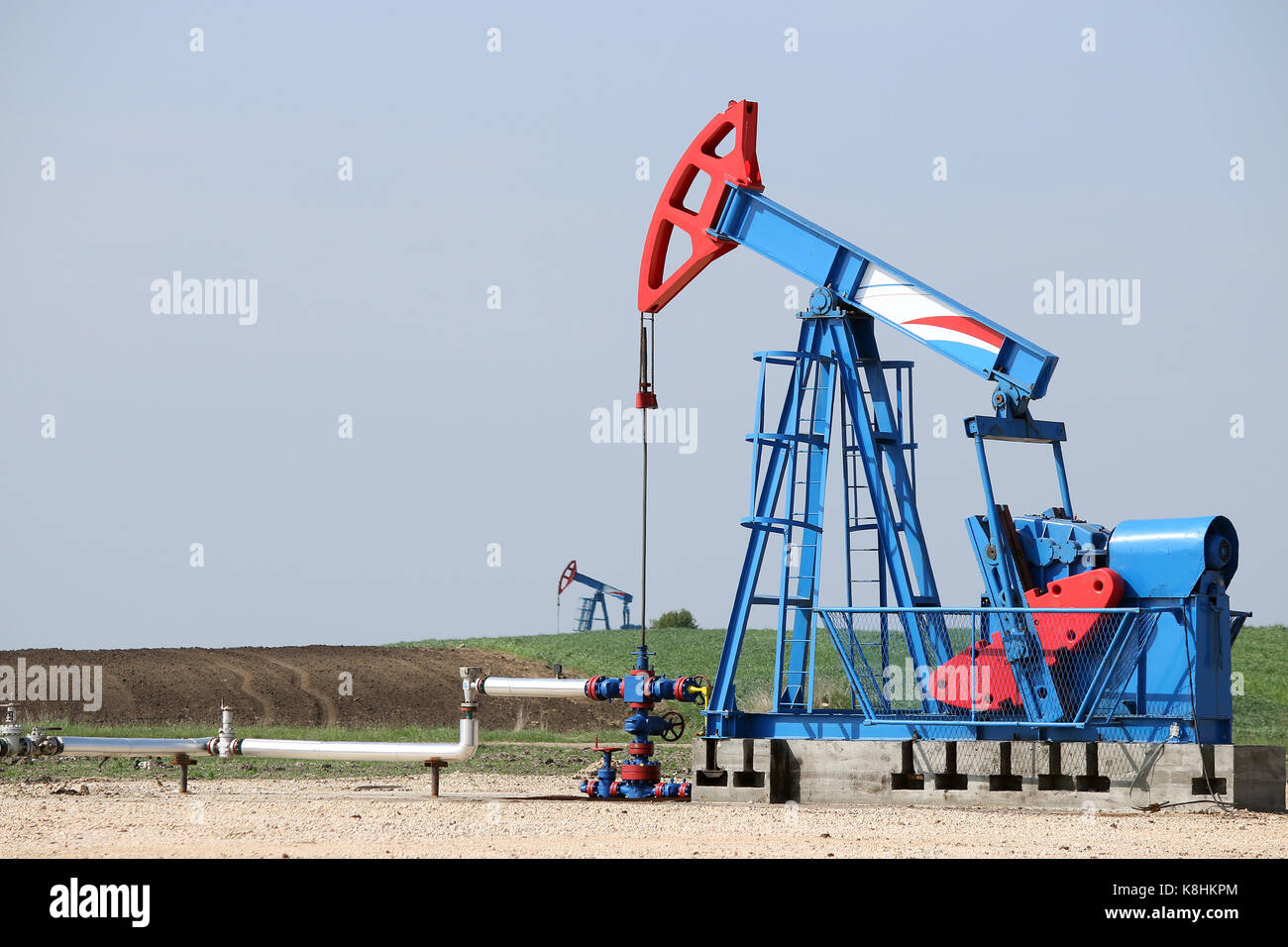 two oil pump jack on oilfield Stock Photo Alamy