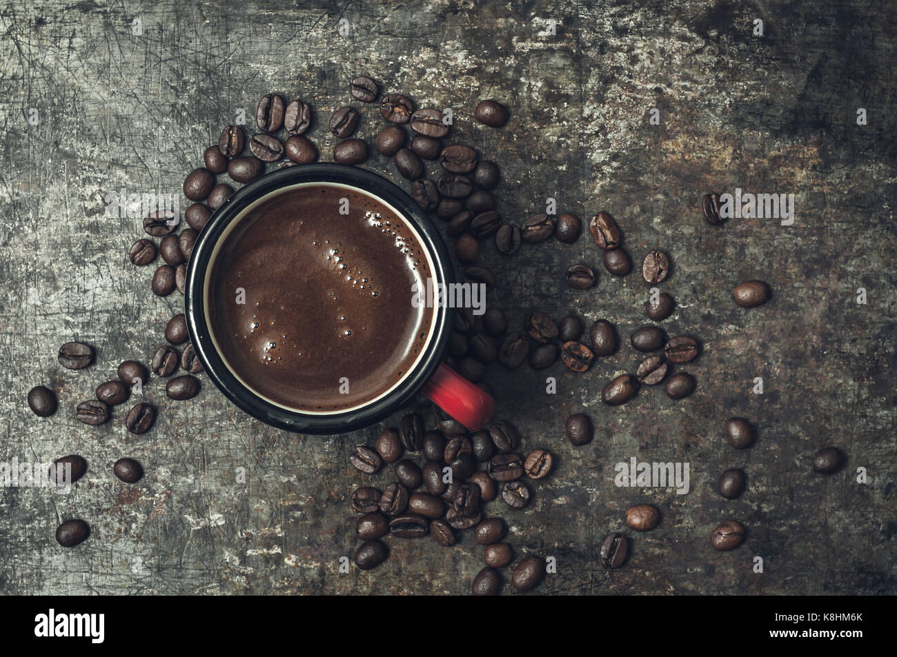 Coffee cup with roasted beans on stone background, from above Stock Photo