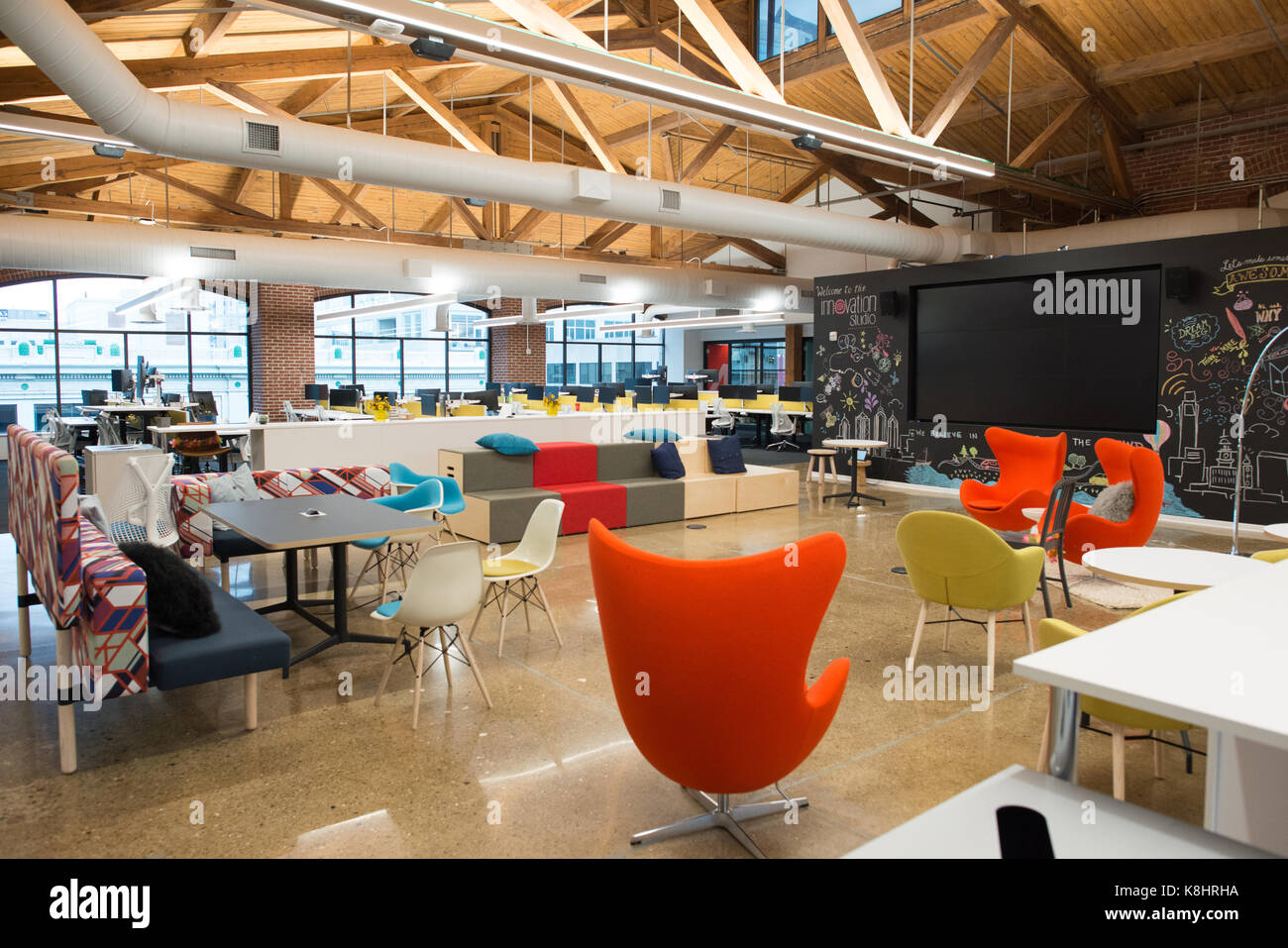 Trendy modern open concept loft office space with big windows, natural light and a layout to encourage collaboration, creativity and innovation Stock Photo