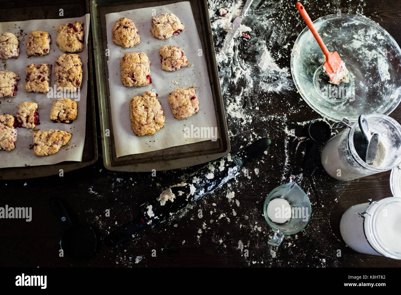High angle view of cookies in baking sheets on messy kitchen Stock Photo