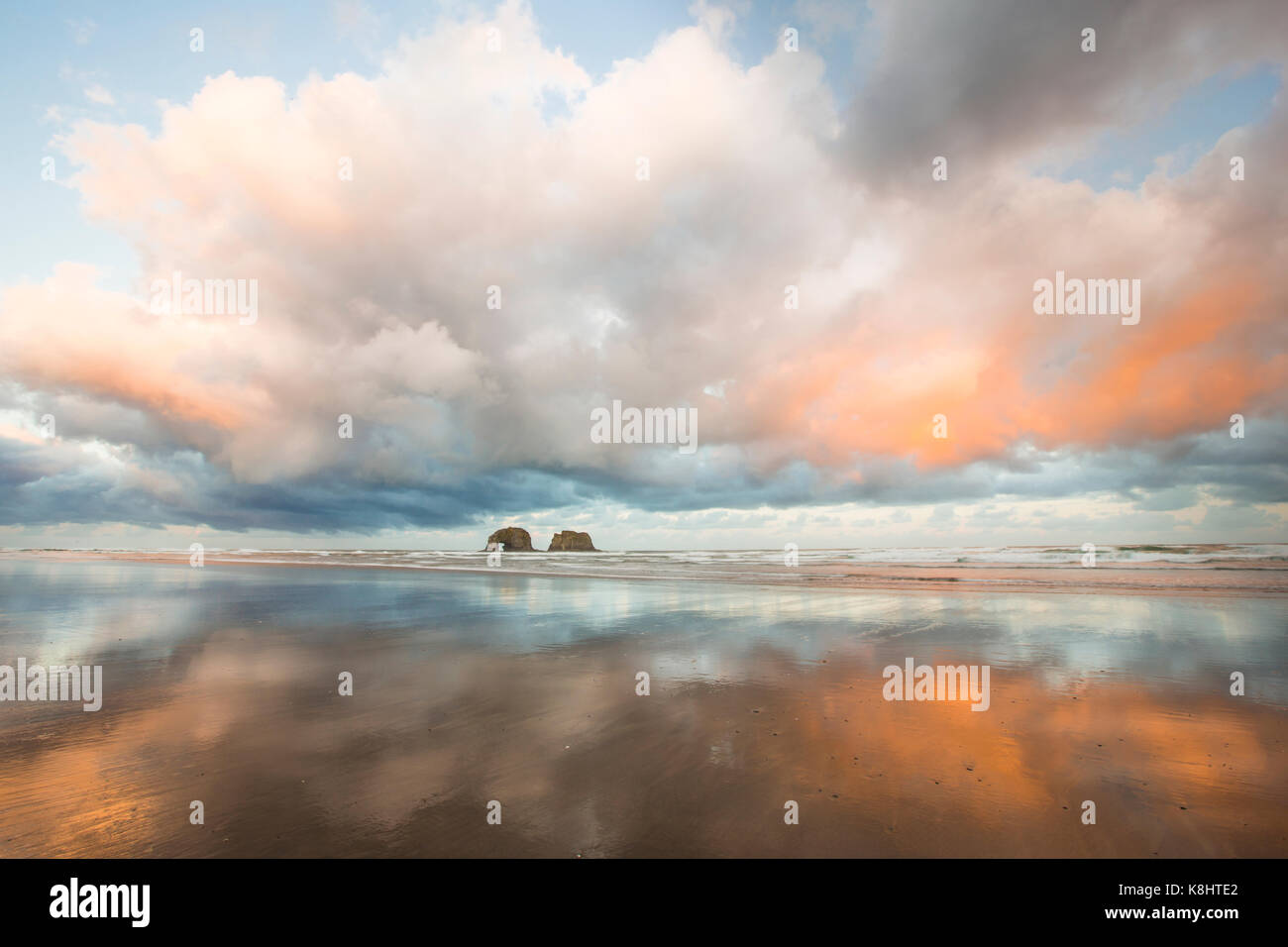 Tranquil view of Rockaway Beach against cloudy sky Stock Photo
