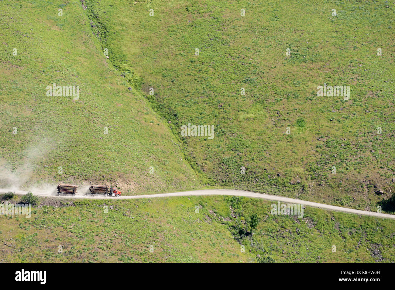 Log truck & trailer on a road on a steep hillside near Troy, Oregon. Stock Photo