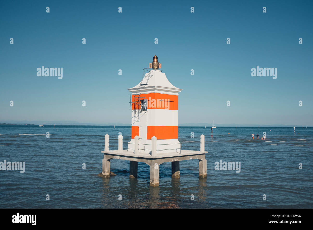 View of lighthouse on sea against clear sky Stock Photo