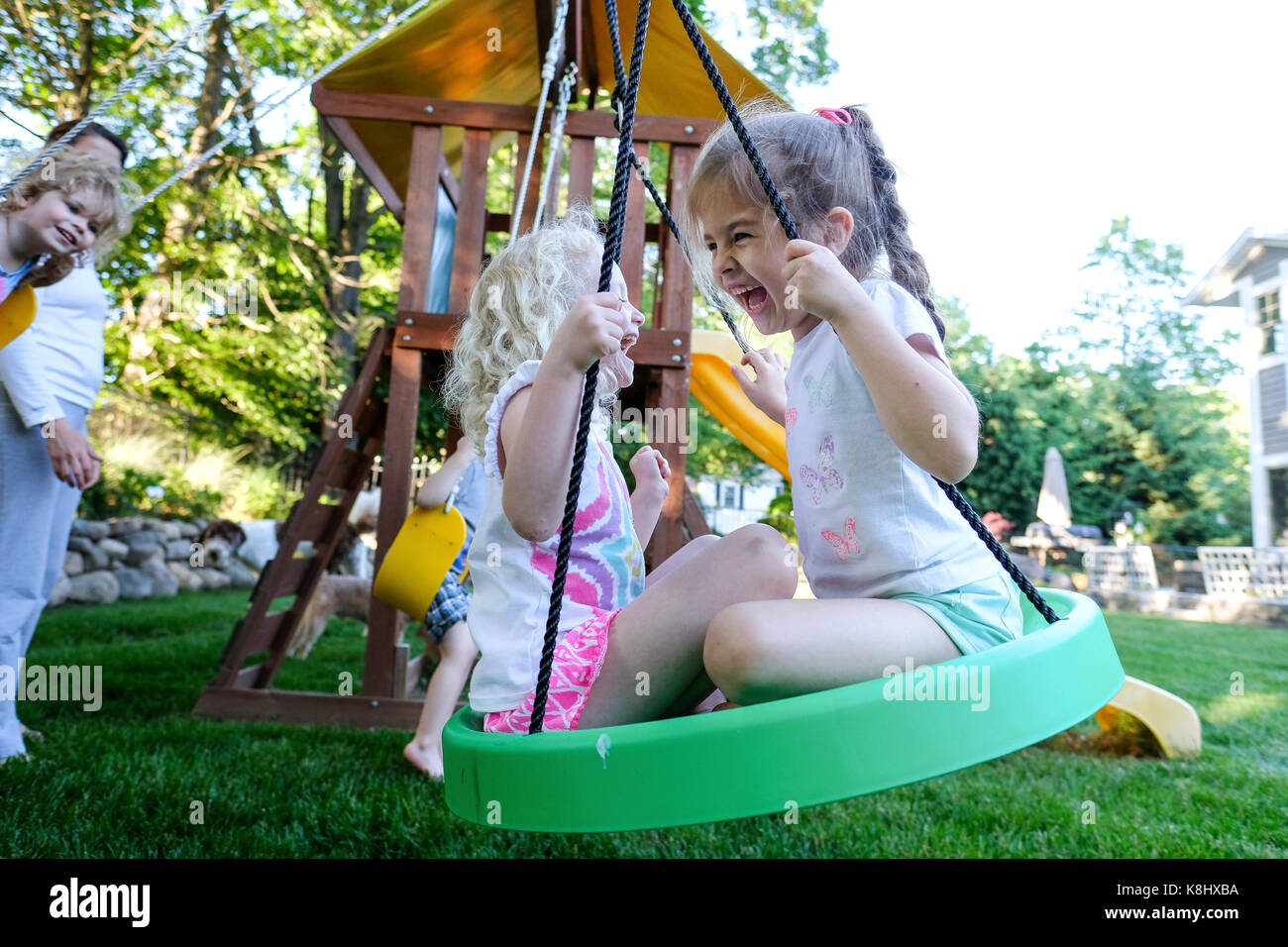 Friends playing on outdoor play equipment at playground Stock Photo
