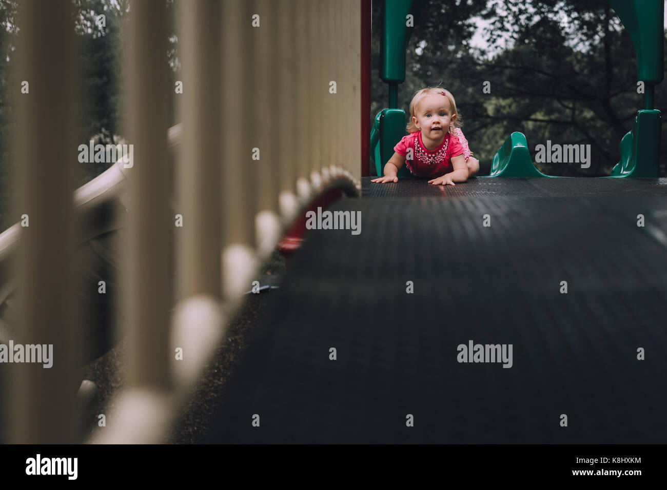Portrait of baby girl on slide at playground Stock Photo Alamy