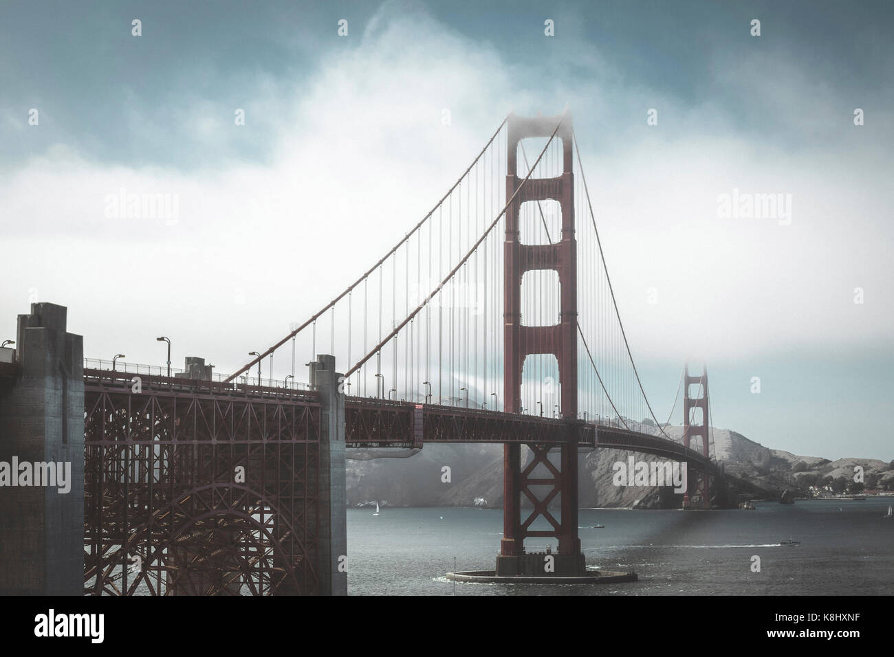View of Golden Gate Bridge over sea against sky during foggy weather Stock Photo