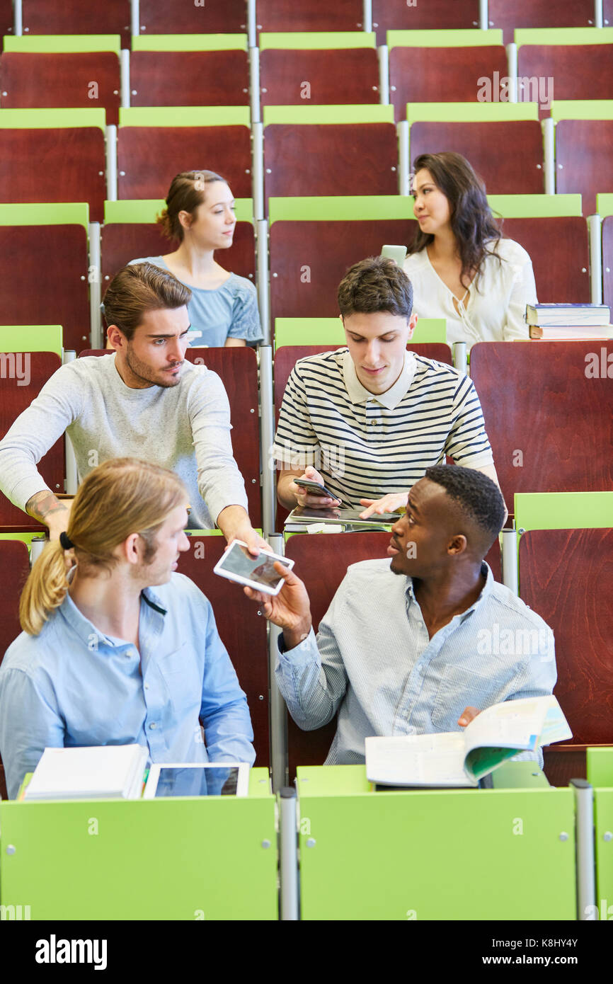 Group of unfocused students in university lecture talking Stock Photo