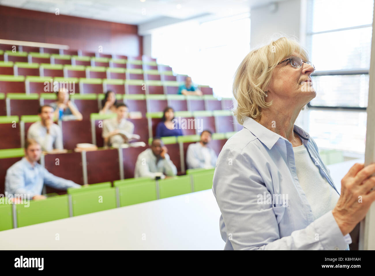 Senior Woman As Math Lecturer In University Lecture Hall Stock Photo