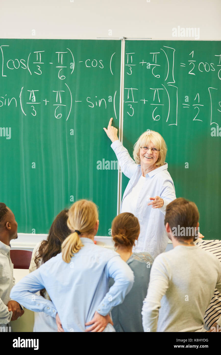 Lecturer teaches math to students and solve formula Stock Photo