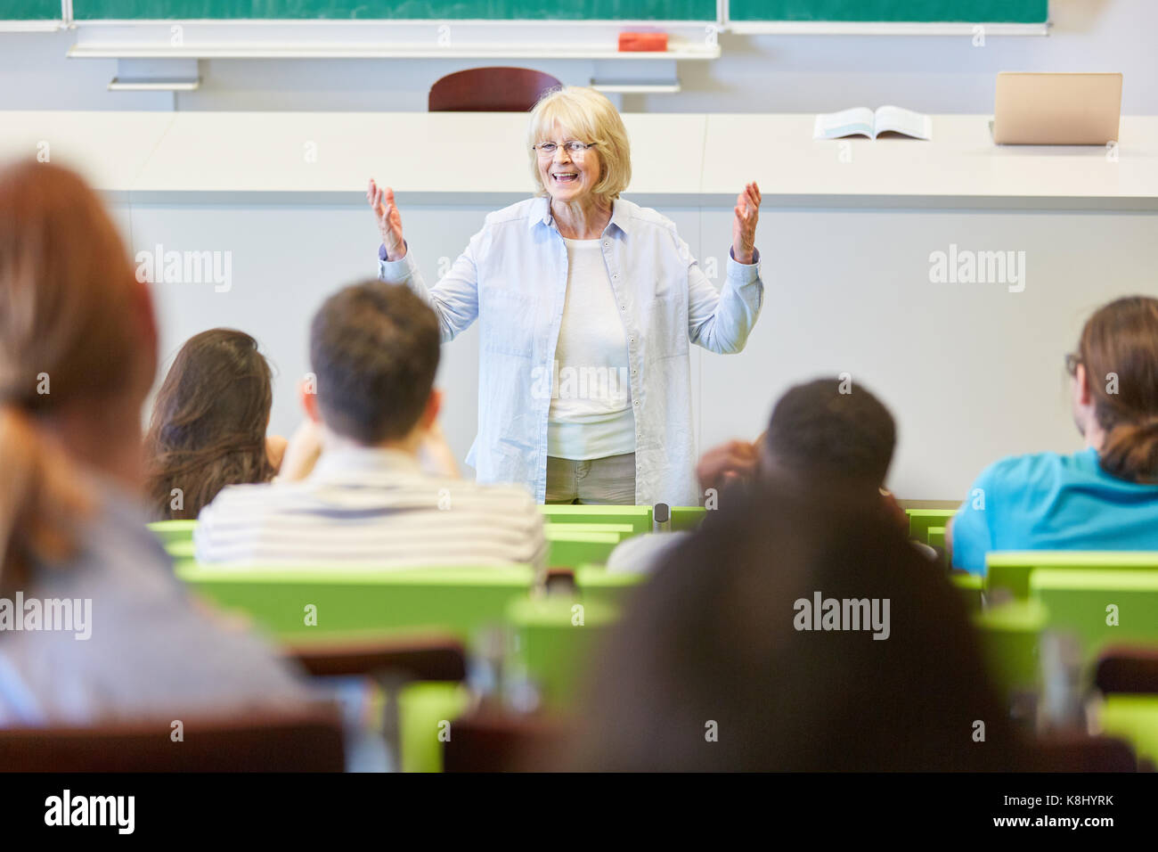 Woman as lecturer teaches students class in university Stock Photo