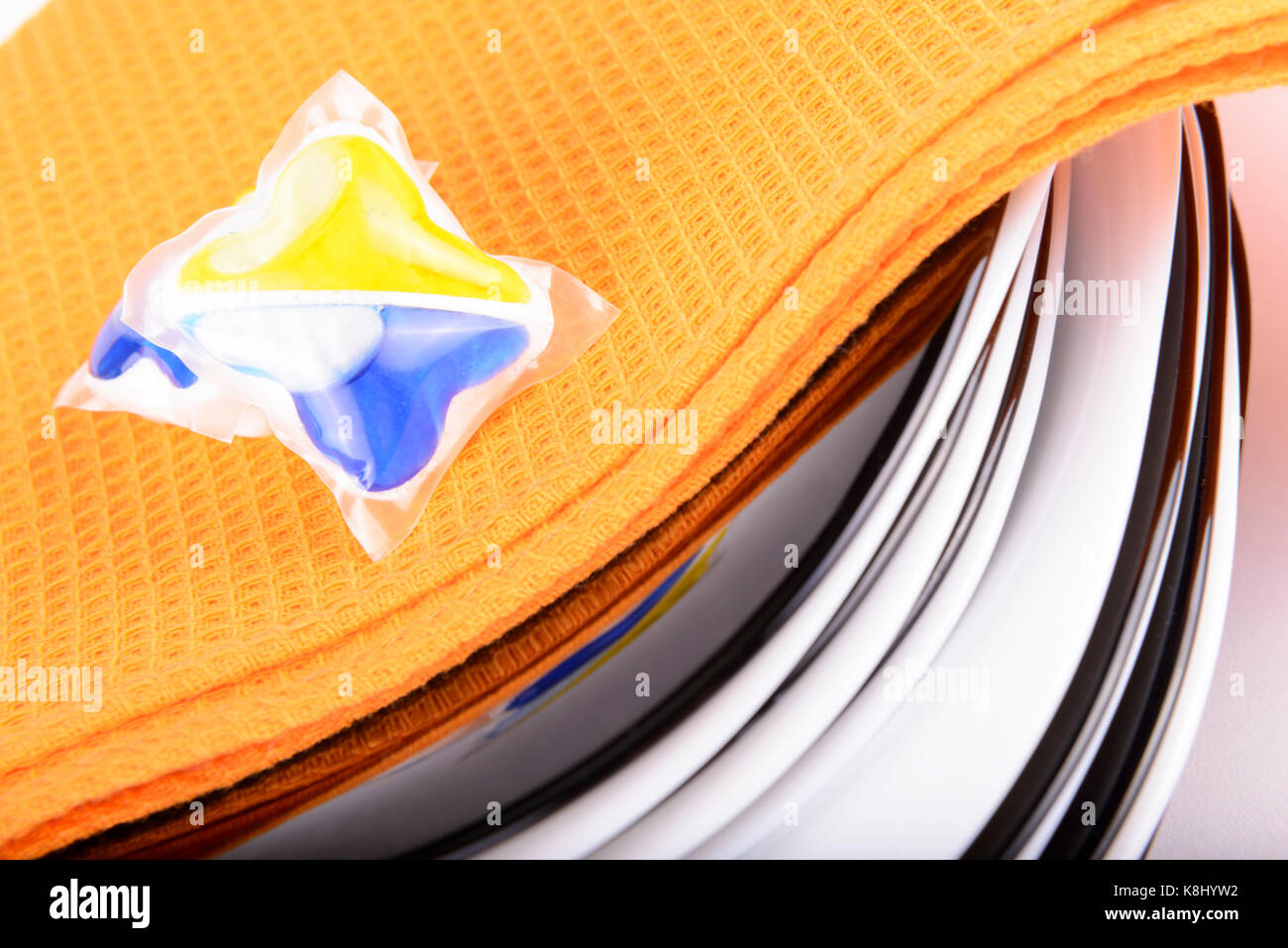 composition of several capsules dishwasher soap with dish Stock Photo