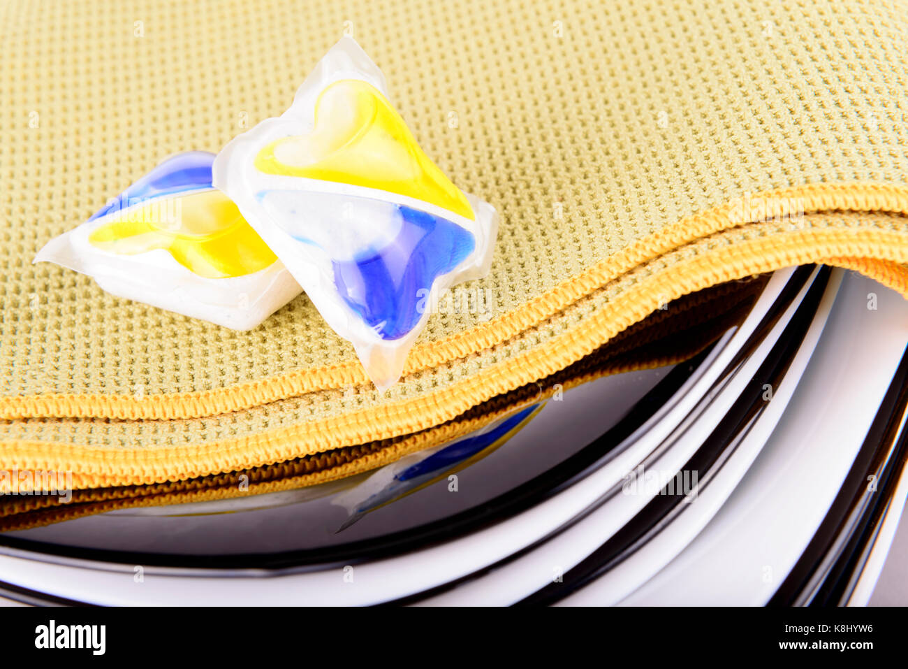composition of several capsules dishwasher soap with dish Stock Photo