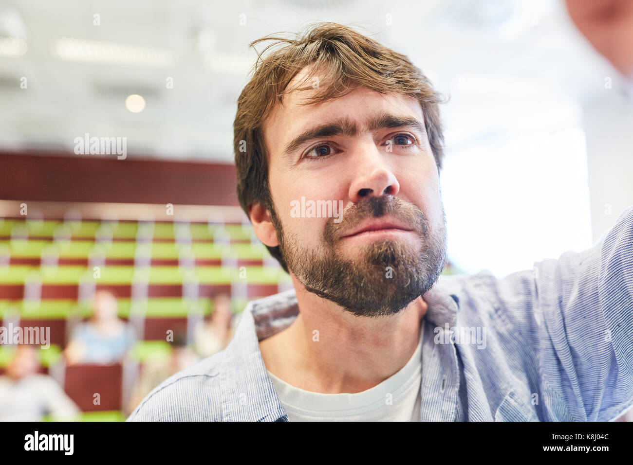 Teacher or lecturer in university or college lecture hall with students Stock Photo