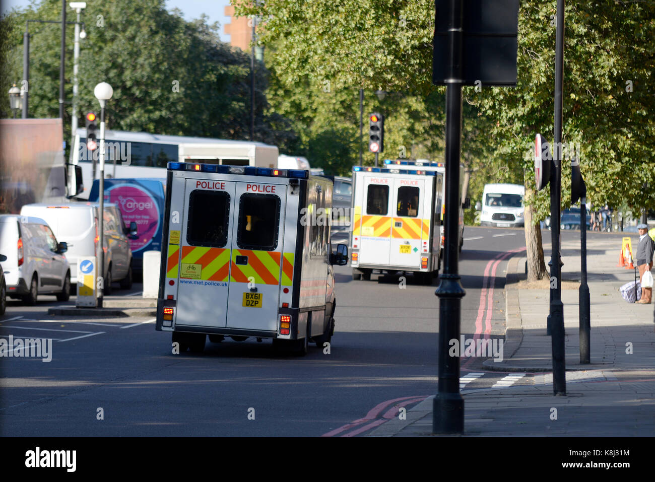 Parsons Green terrorist bomb. Police vans racing towards the incident on blue lights. Wrong side of the road Stock Photo