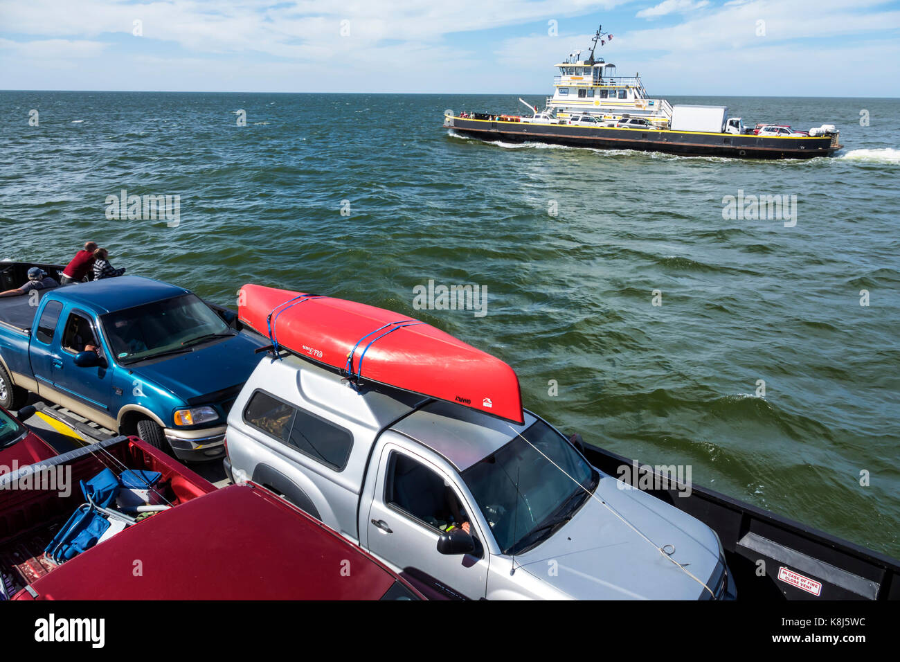 North Carolina,NC,Outer Banks,Pamlico Sound,Ocracoke Island,Hatteras,ferry,water,navigating,vehicles,waves,passing boat,carrying canoe,NC170518137 Stock Photo