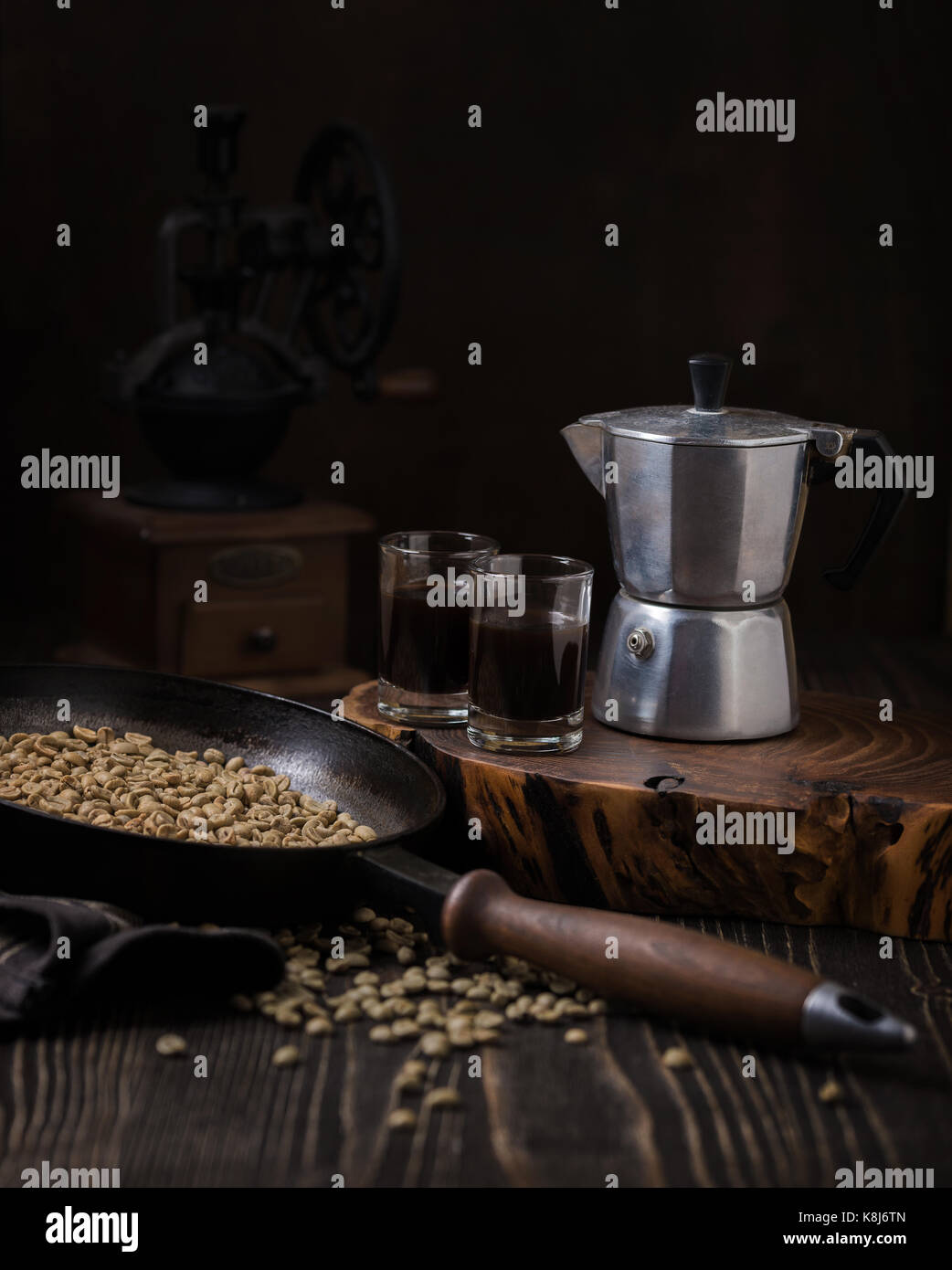 Still life with espresso machine and unroasted coffee beans
