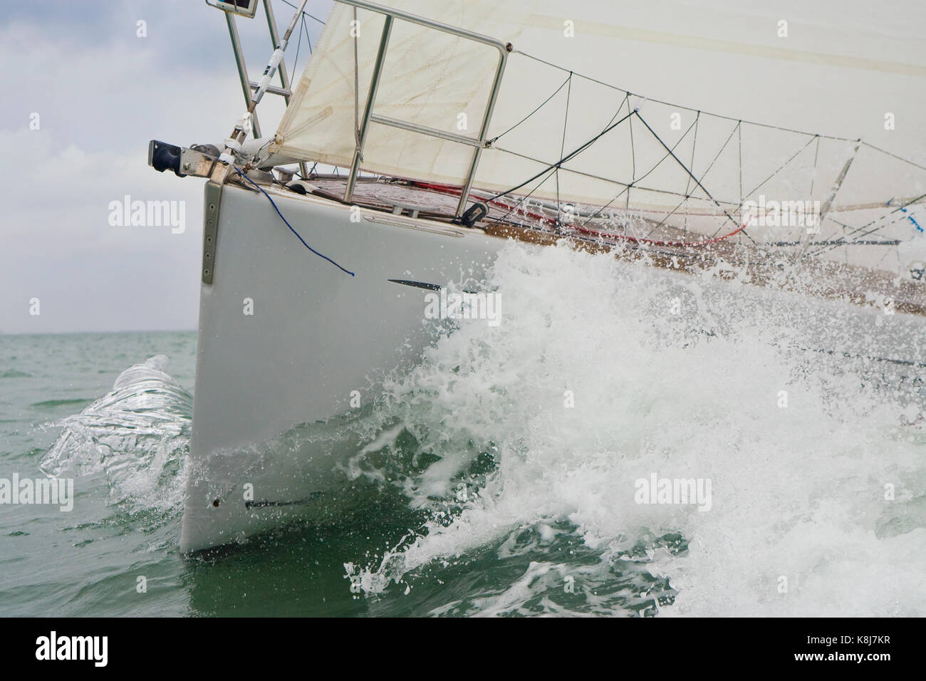 Close up bow and wave of a sailing boat, sail boat or yacht at sea Stock Photo