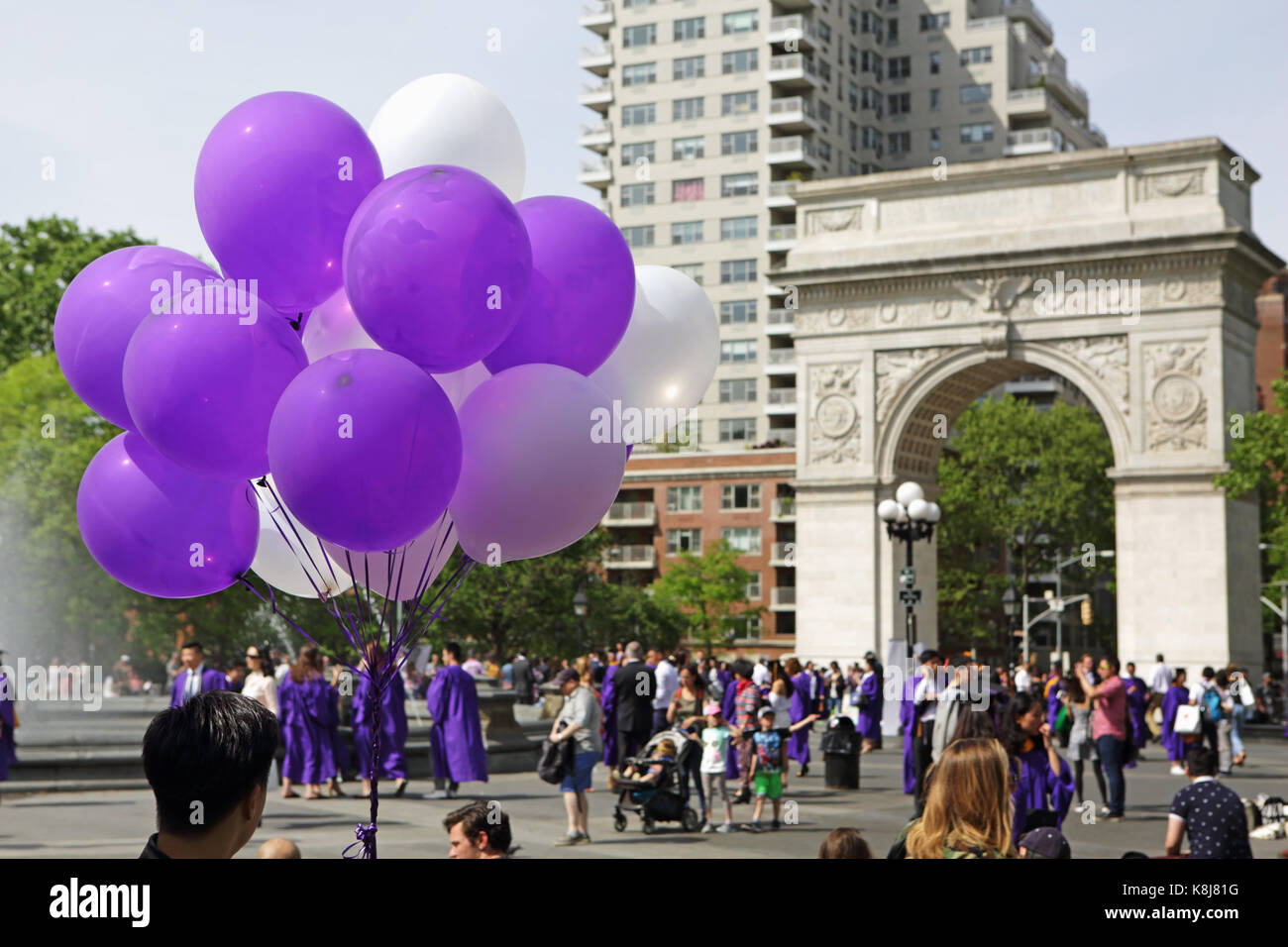 New York, NY, USA - May 16, 2017: New York University students, in caps and gowns, gather in Washington Square Park to celebrate graduation Stock Photo