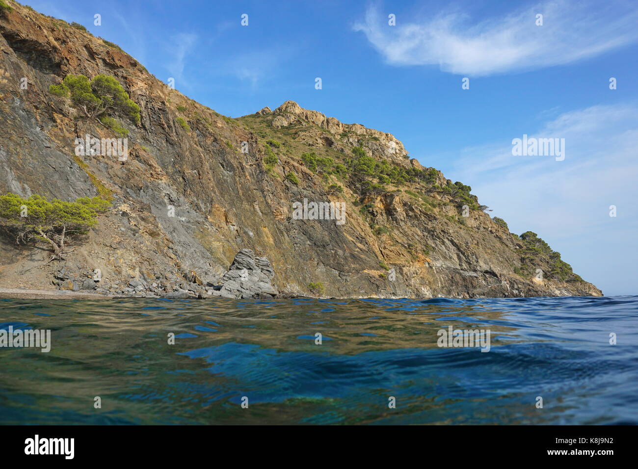 Spain Costa Brava coastal landscape cliff seen from water surface, Cap Norfeu, Mediterranean sea, Alt Emporda, Girona, Catalonia Stock Photo
