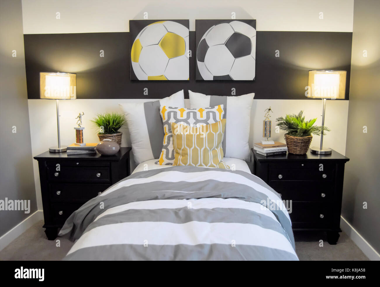 A Soccer Decorated Bedroom With A Single Bed And Nightstands Stock