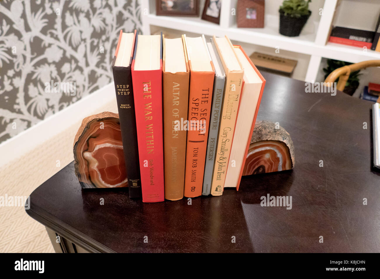 A Row Of Books Held By Wonderstone Book Stoppers On A Desk Stock