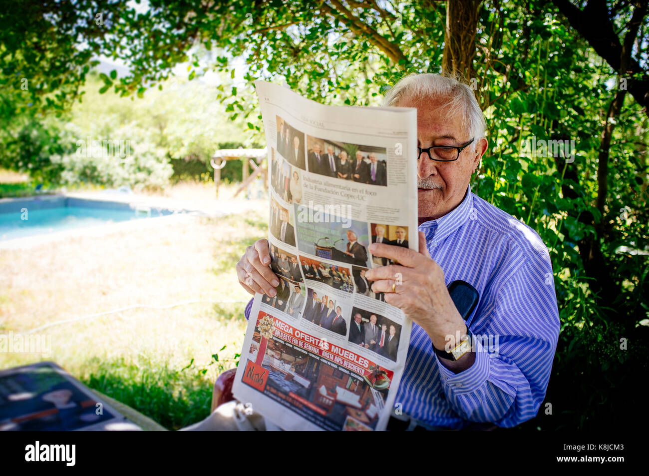 Senior adult man reading newspaper in the garden Stock Photo Alamy