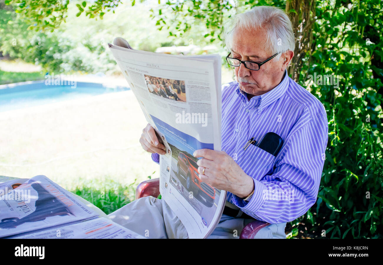 Senior adult man reading newspaper in the garden Stock Photo Alamy