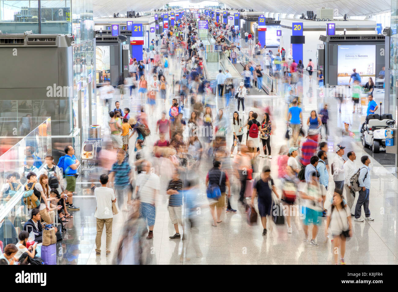 HONG KONG - JULY 16, 2017: Passengers at the departure terminal of Hong Kong Chek Lap Kok International Airport, the world's busiest cargo gateway and Stock Photo