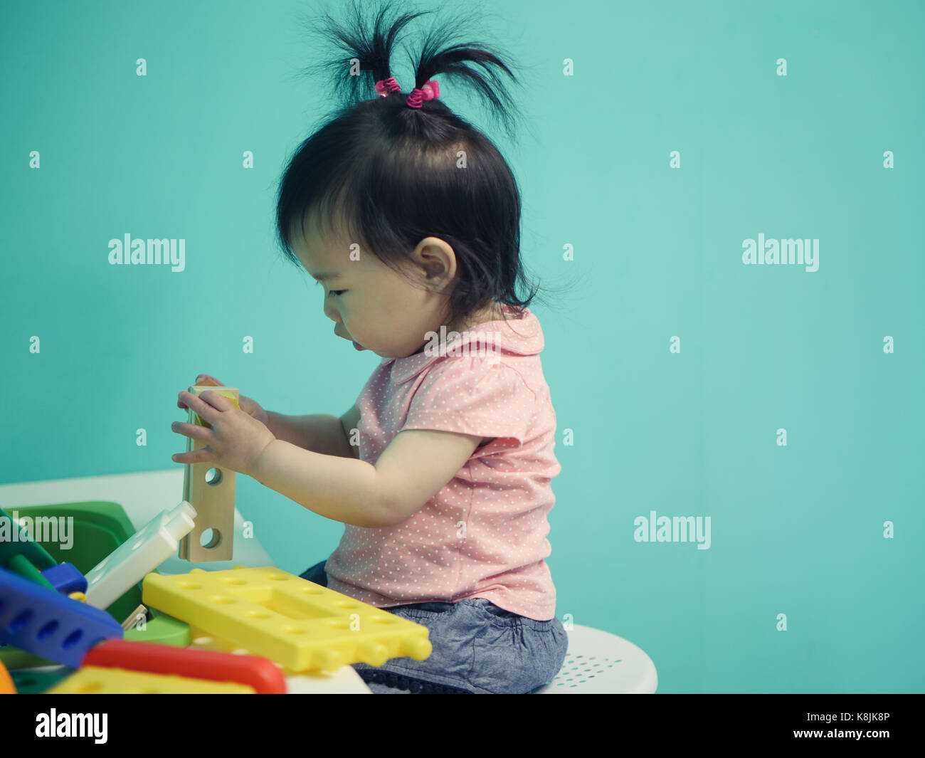 baby girl playing toy at home Stock Photo - Alamy