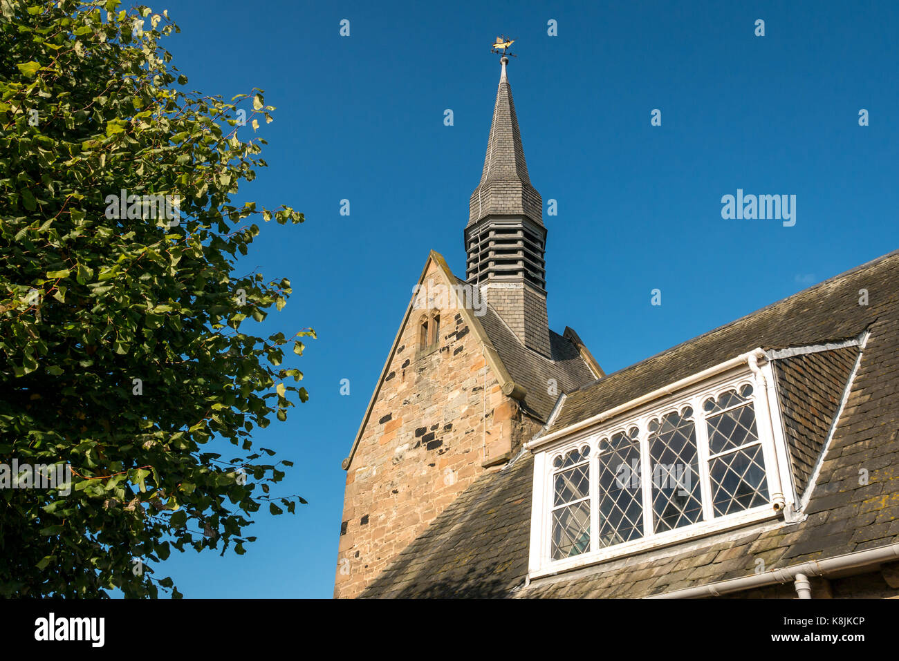 Spire and country style window, Presbyterian Chalmers Memorial Church, Port Seton, Scotland, UK by architects Sydney Mitchell and George Wilson Stock Photo