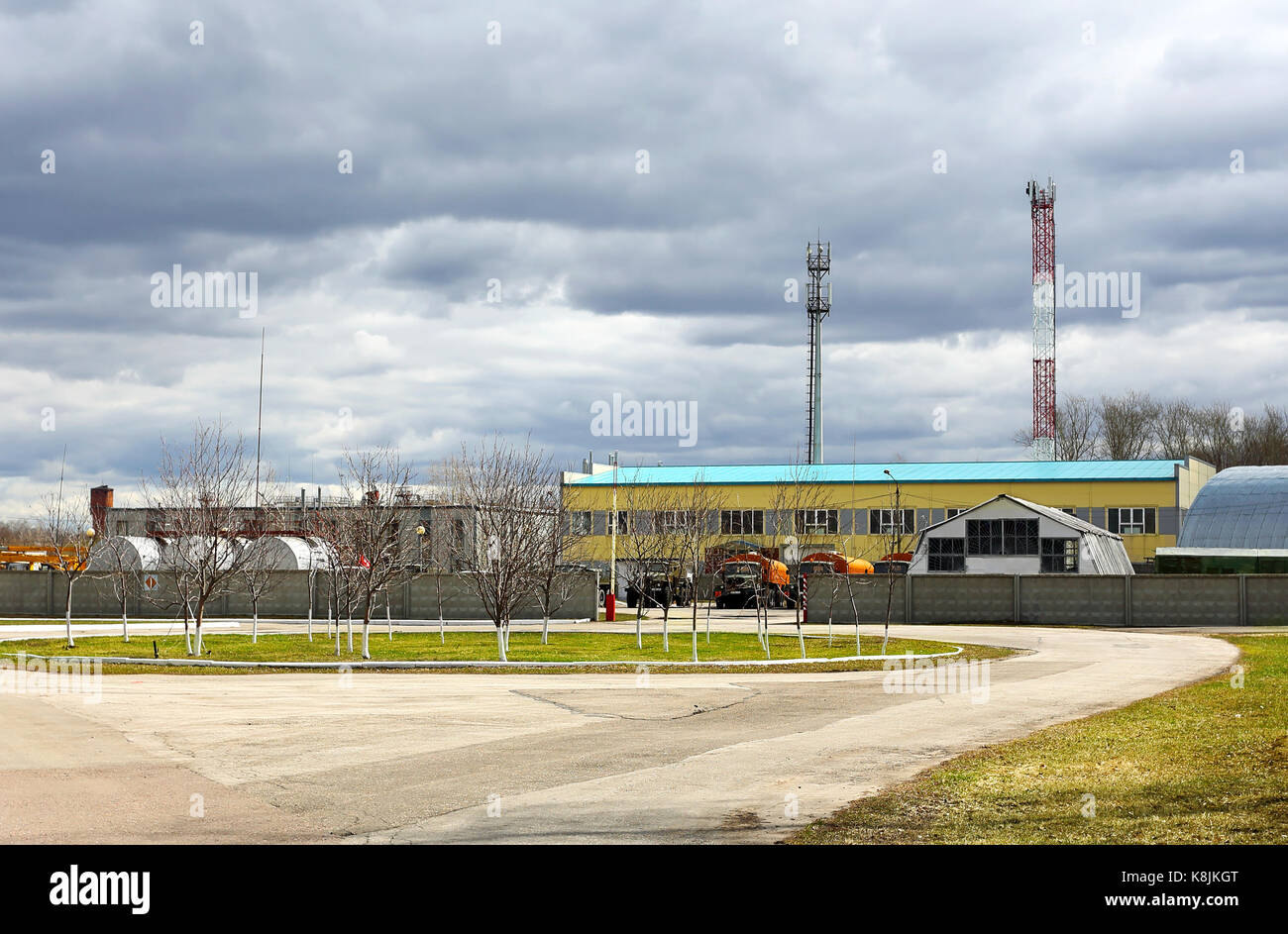 Large indusrtial facilities with  the stock of the construction equipment and trucks nearby Stock Photo