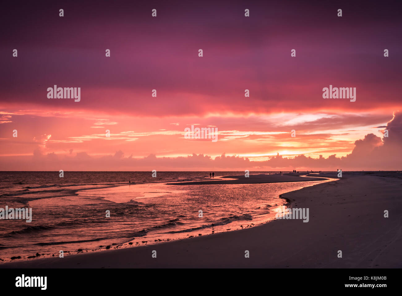 sunset at the beach with silhouettes Stock Photo - Alamy