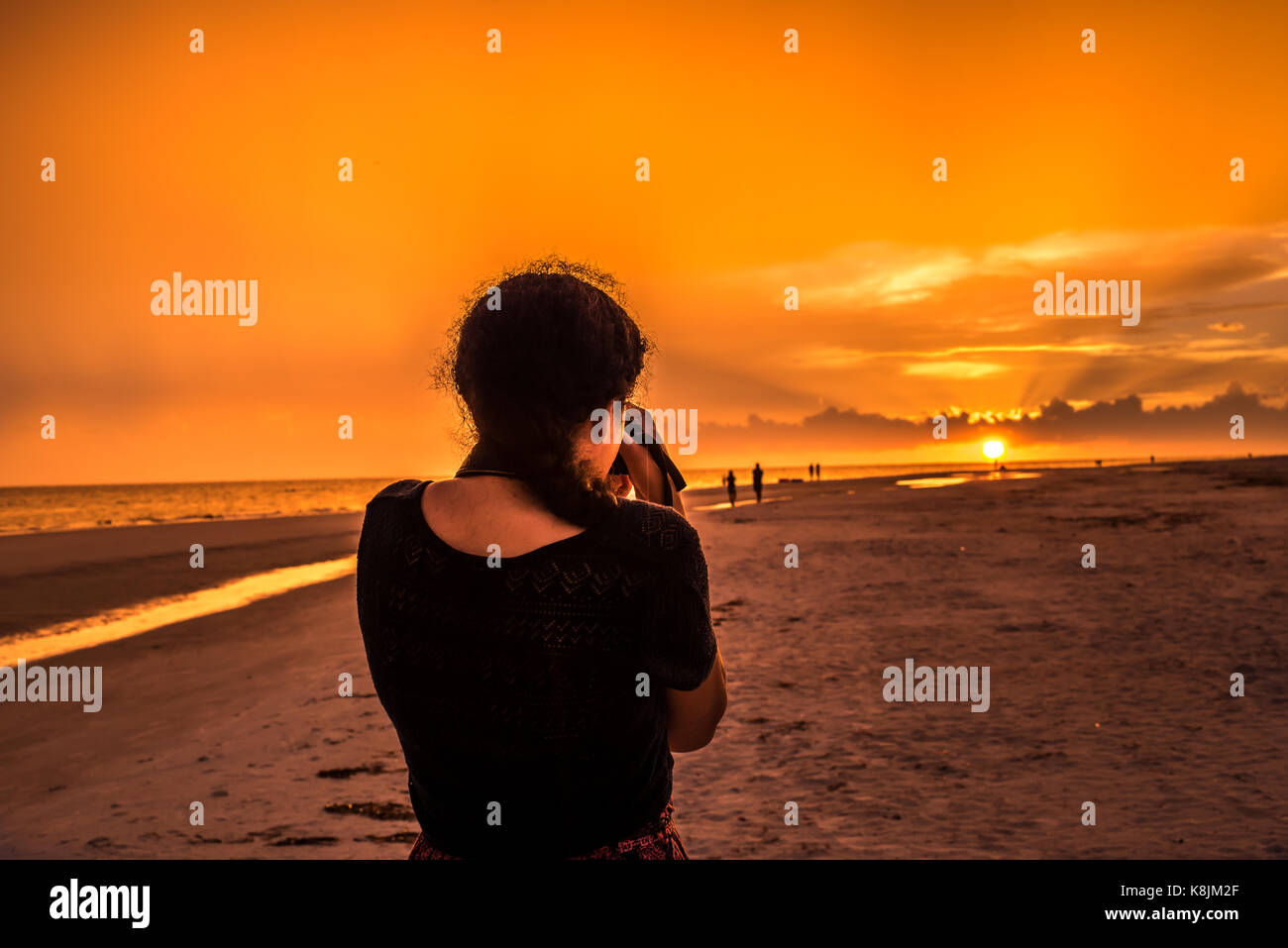 sunset at the beach with silhouettes Stock Photo - Alamy