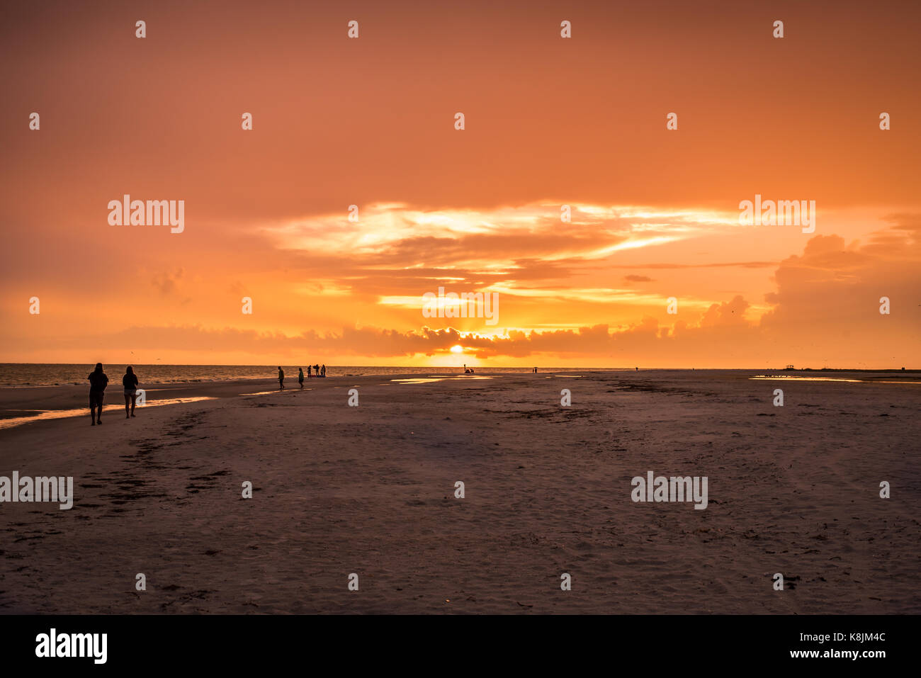 sunset and silhouettes at the beach Stock Photo - Alamy
