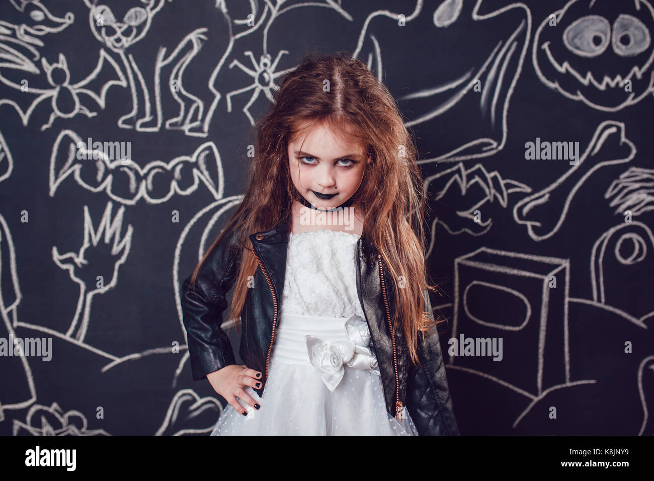 Girl in Bride of Chucky Doll costume on dark background with Halloween  illustrations Stock Photo - Alamy