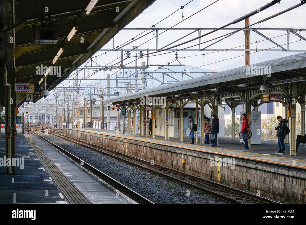 Tokyo, Japan - Dec 25, 2015. People waiting for the train at Hachioji railway station in Tokyo, Japan. Railways are the most important means of passen Stock Photo